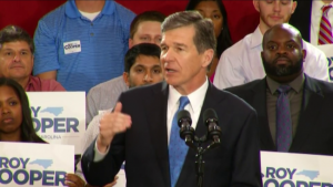 Attorney General Roy Cooper is a automaton of the Obama administration, say his detractors.