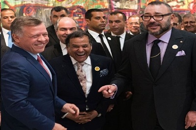 King Abdullah II of Jordan (L) arrives at the inauguration of an exhibition in the Museum Mohamed VI of Modern and Contemporary Art, where he is received by King Mohamed VI of Morocco (R) and painter Mehdi Qotbi (C), in the Moroccan capital Rabat on March 23, 2017.  