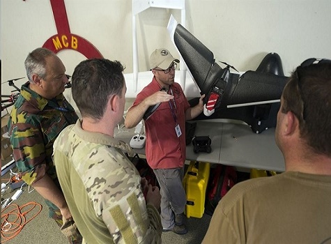 Intelligence analyst B. Joshua Bauer discusses terrorists' use of commercially available unmanned aircraft with U.S. and Belgian explosive ordnance disposal teams during the Raven's Challenge exercise at Camp Pendleton, Calif., Aug. 1, 2017. DoD photo by EJ Hersom